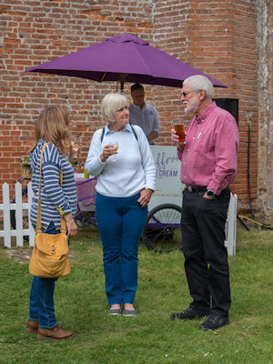 Visitors enjoying an ice cream in the sun.